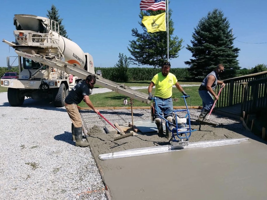 Workers spreading concrete